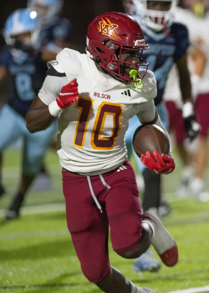 Wilson’s Jemel Grigsby runs the ball for a gain during...