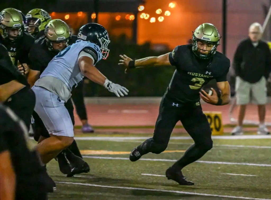 Mira Costa quarterback Wyatt Nucci rushes with the ball during...
