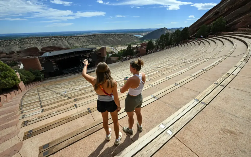 Visitors to Red Rocks look over the amphitheater in Morrison,...