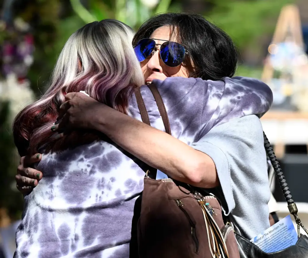 Stephanie Kirianoff, from Culver City, embraces another after she spoke...