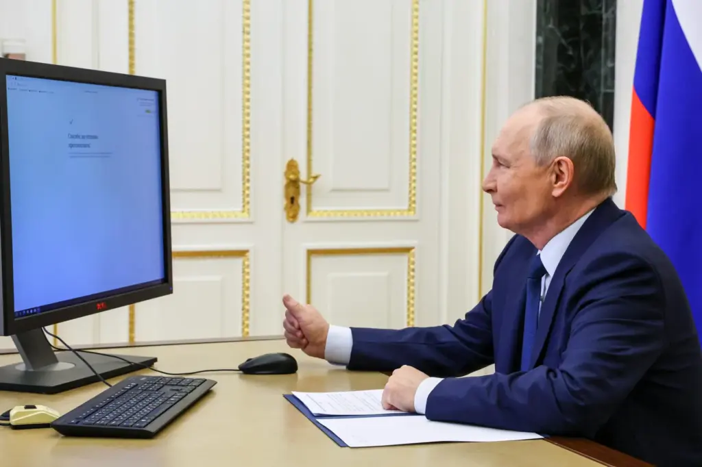 Russian President Vladimir Putin votes online in the parliamentary election,...