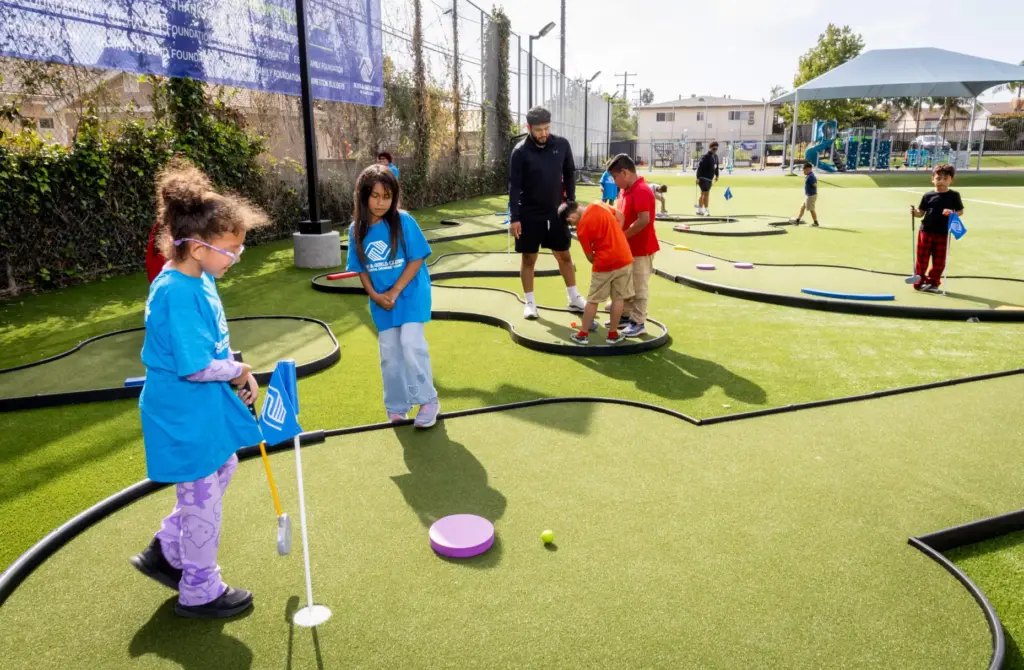 Hannah Cabeda, 9, practices her golf putting skills as her...