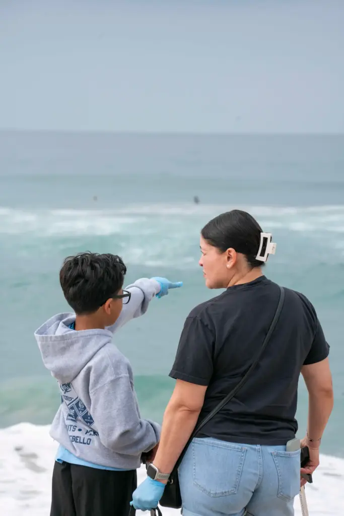 Adrian Arguello and Veronica Maldonado look at the waves together...