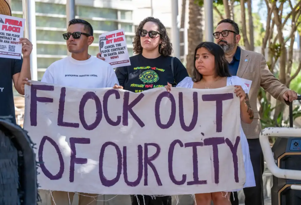 Privacy advocates hold signs during a press conference for the...