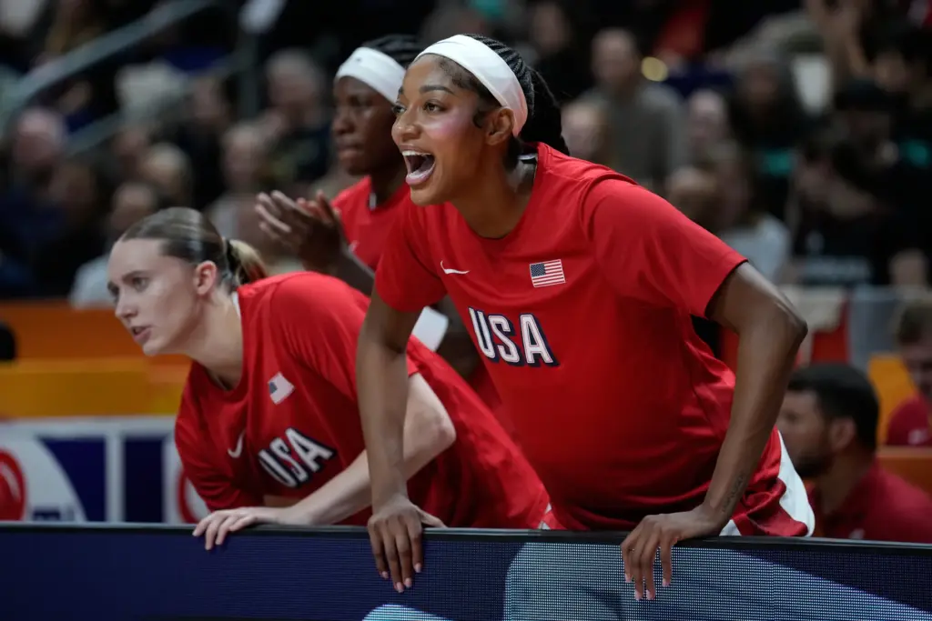 Team USA forward Angel Reese reacts from the bench during...