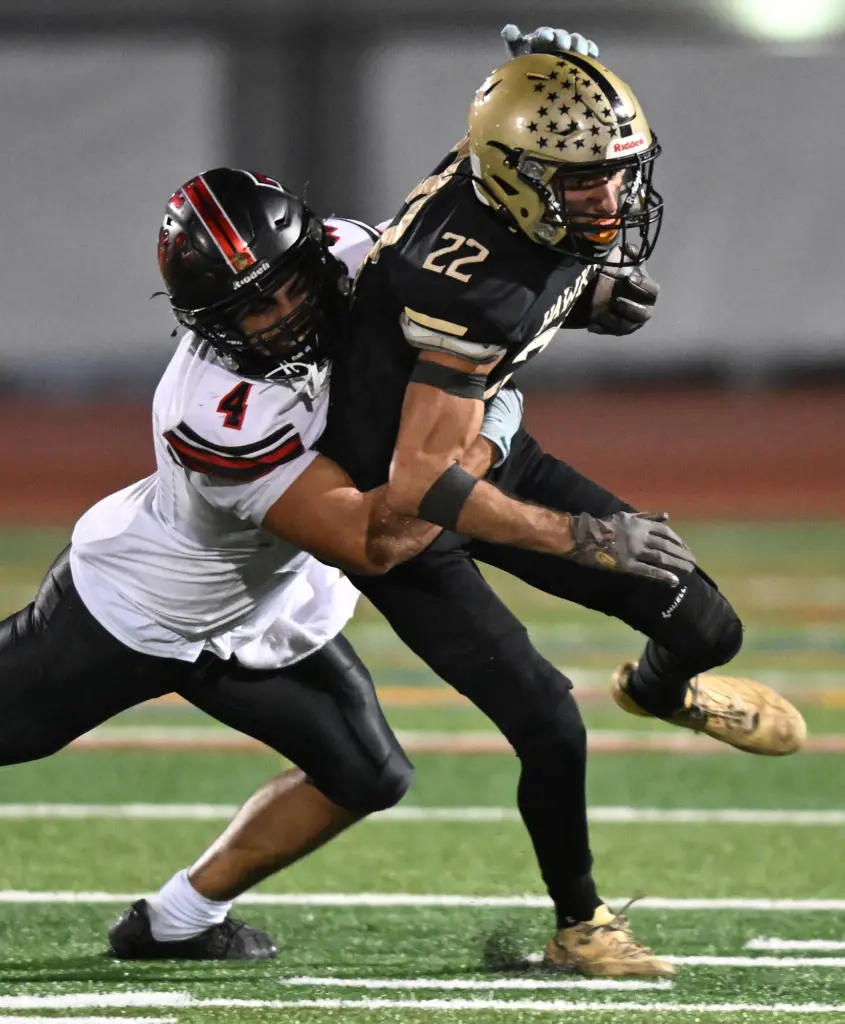 Roy Bouakar #4 of Troy tackles Darius Selway #22 of...