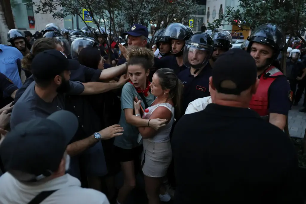 Police officers clash with protesters during ongoing demonstrations against plans...