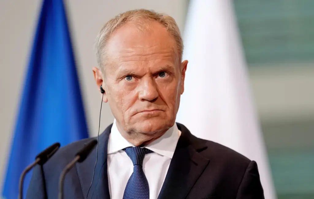 FILE – Polish Prime Minister Donald Tusk looks on during...