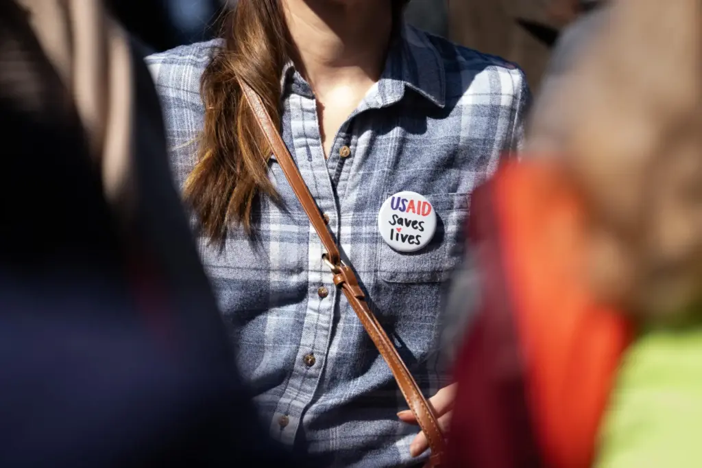 FILE – Former USAID staff and supporters rally to mark...
