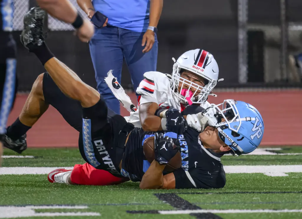Villa Park wide receiver Wil Cassara, front, is thrown to...