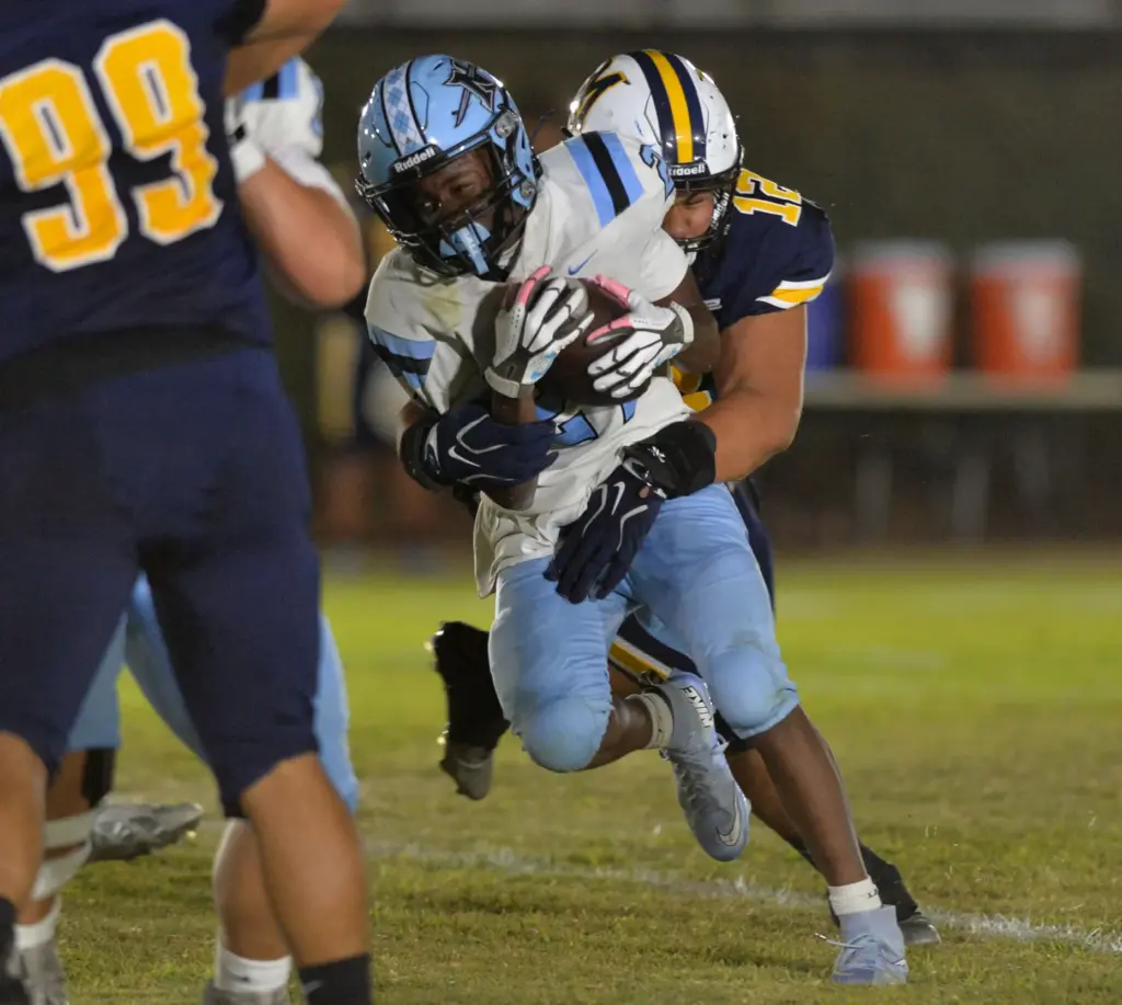 North Torrance back Greyson Gales gets wrapped up by Mary...