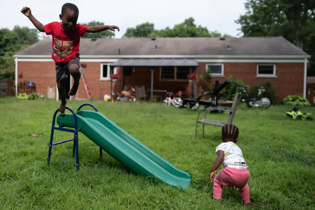 Khalidou Sy’s children play in the backyard of the family’s...