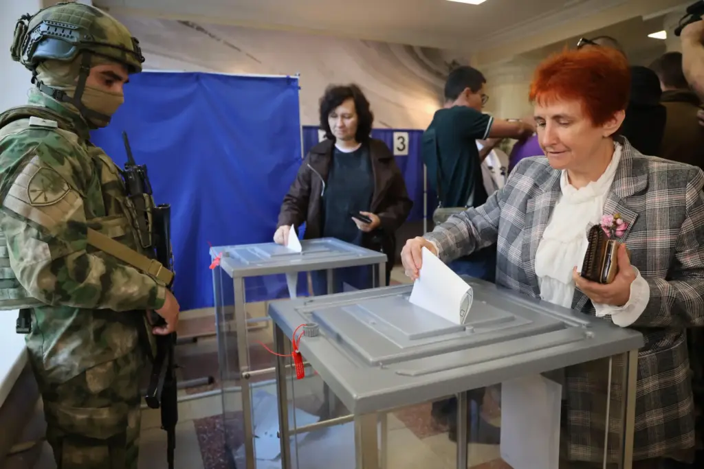 Voters cast ballots at a polling station during Russia’s parliamentary...