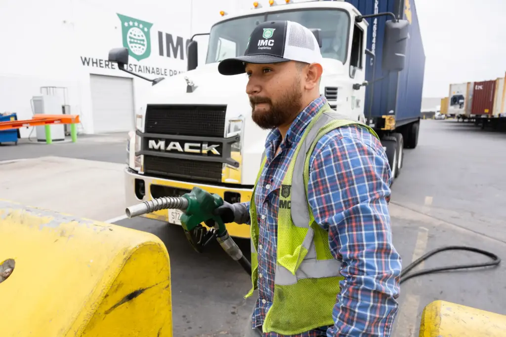 Truck driver Juan Delgadillo tops off his diesel truck at...