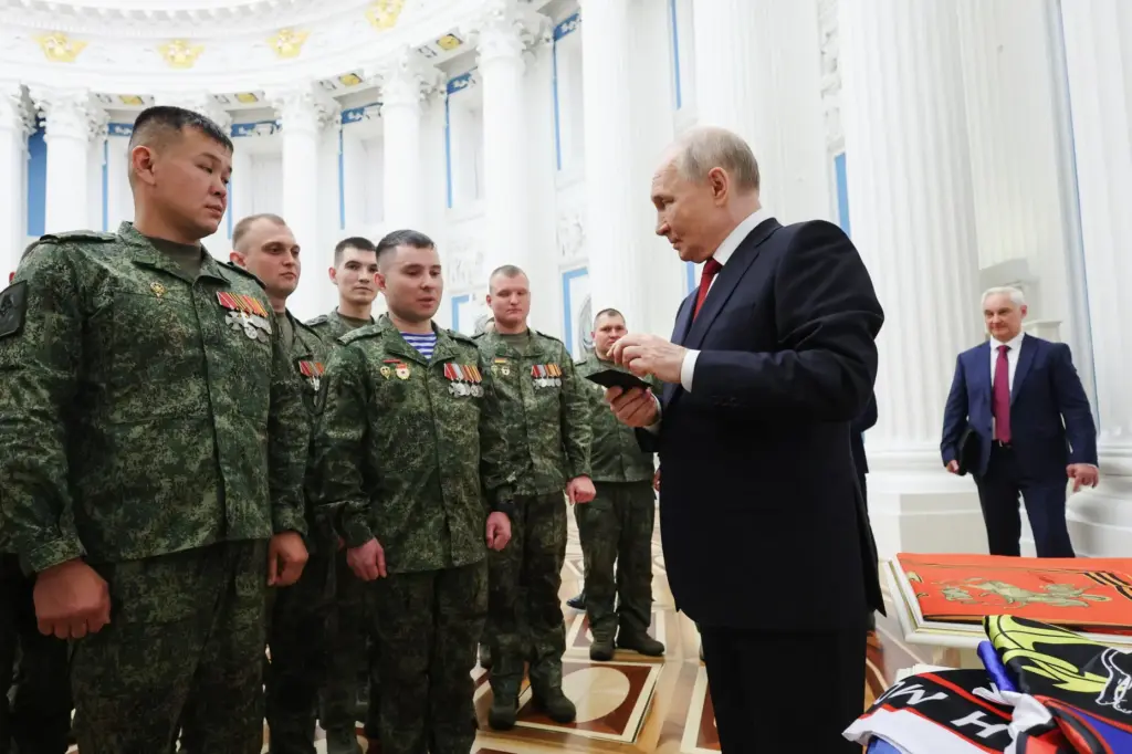 Russian President Vladimir Putin speaks with members of the military.
