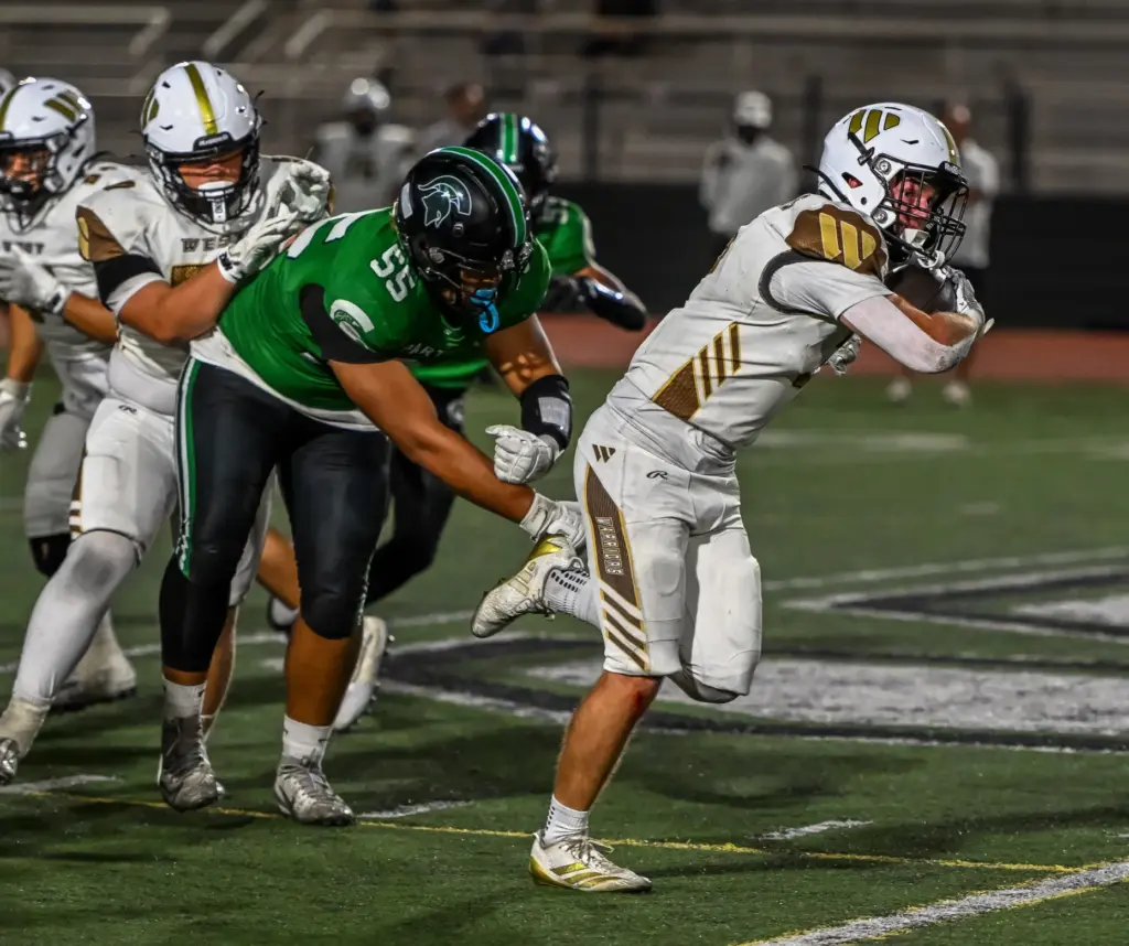 West Torrance running back Jack MacInnis runs with the ball...