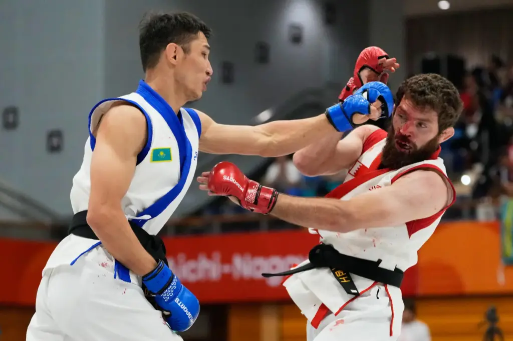 Mukhammad Nabiev of Bahrain competes against Yerkingali Burkutalin of Kazakhstan.