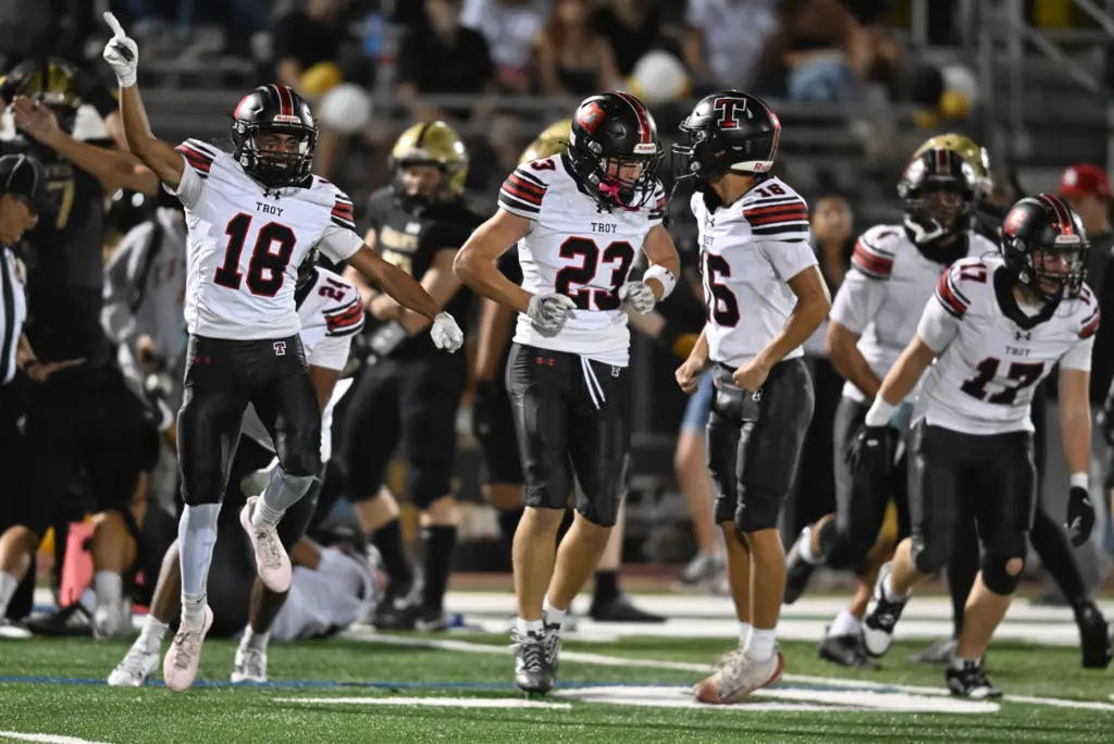 Troy celebrates a fumble recovery in the first half. El...