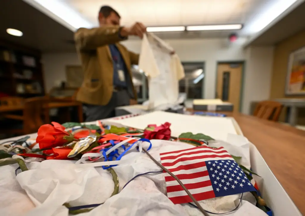 Professor David G. Schwartz looks over artifacts that were part...