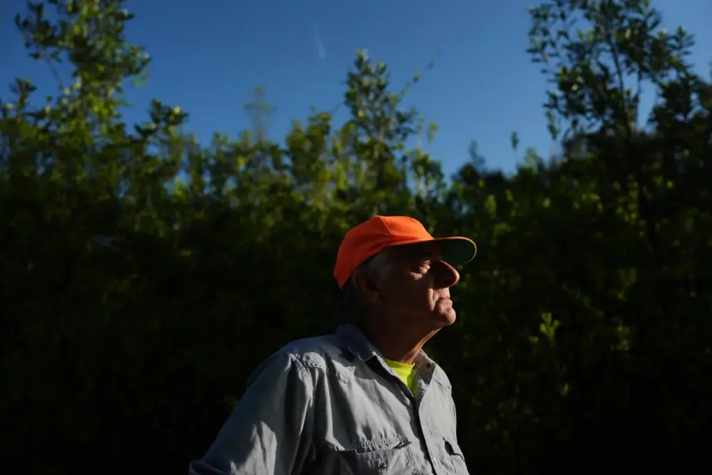 Steve Apfelbaum, a biologist and ecologist, listens for bird calls...