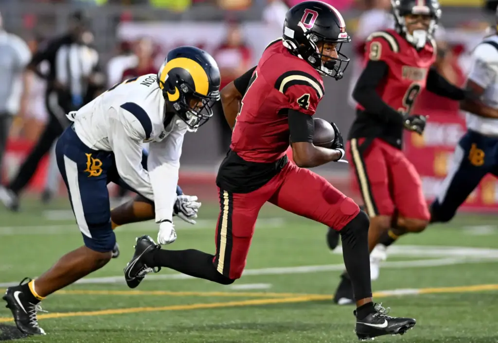 Downey’s Damani Porras (4) runs for a touchdown in the...