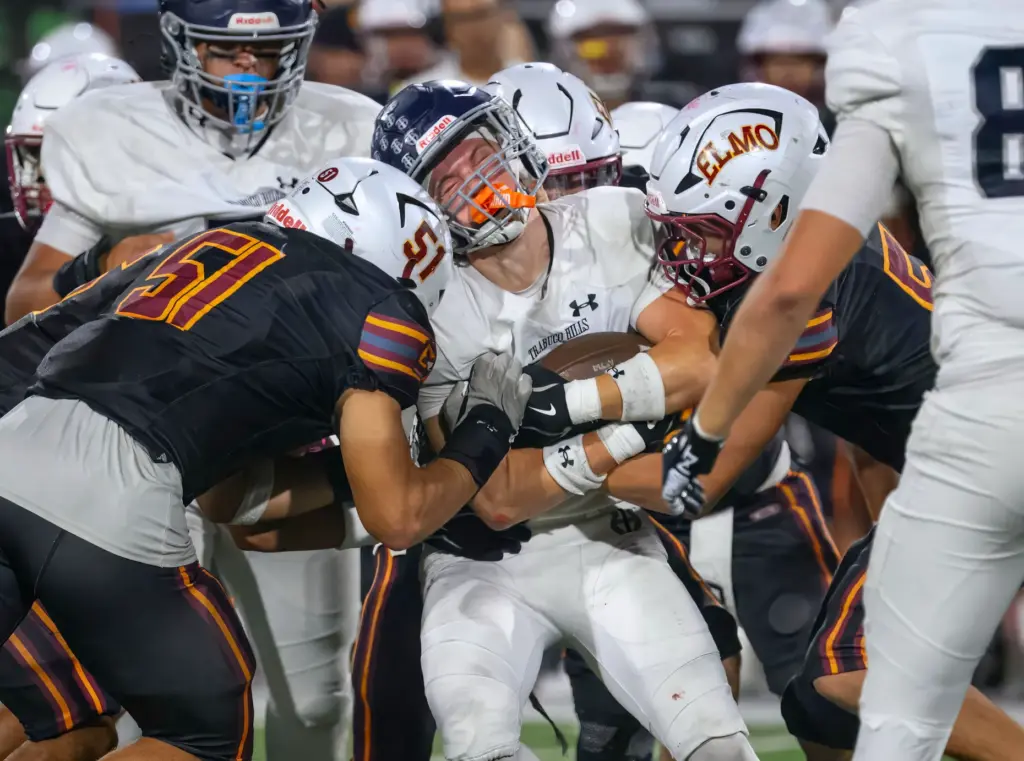 Trabuco Hills running back Luke Hoffman is hit by El...