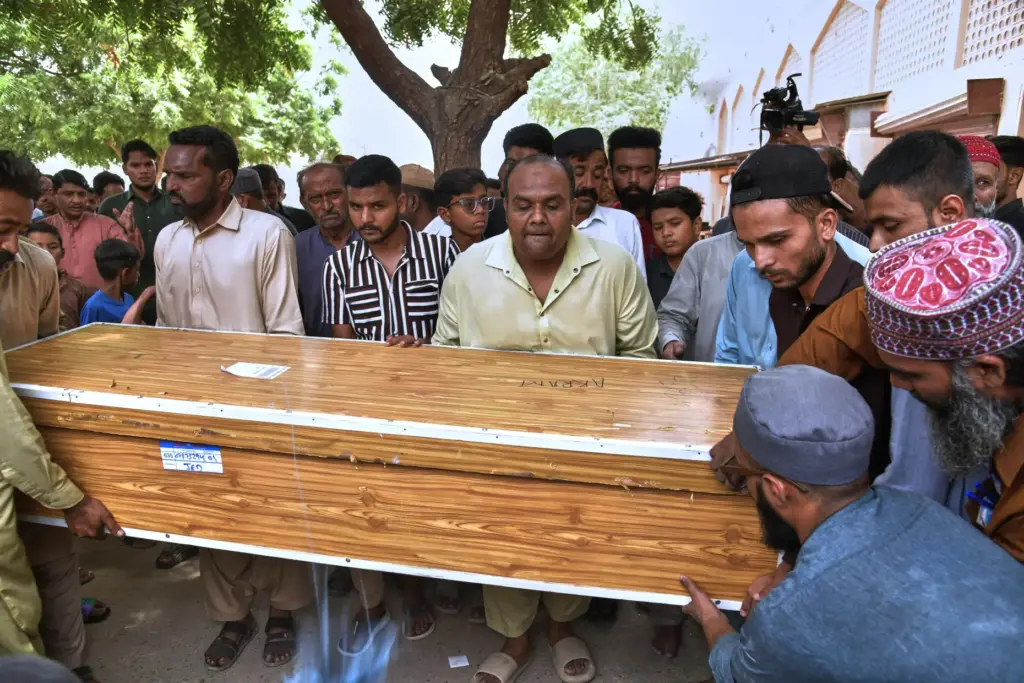 Mourners carry the casket of Muhammad Akram, who was killed...