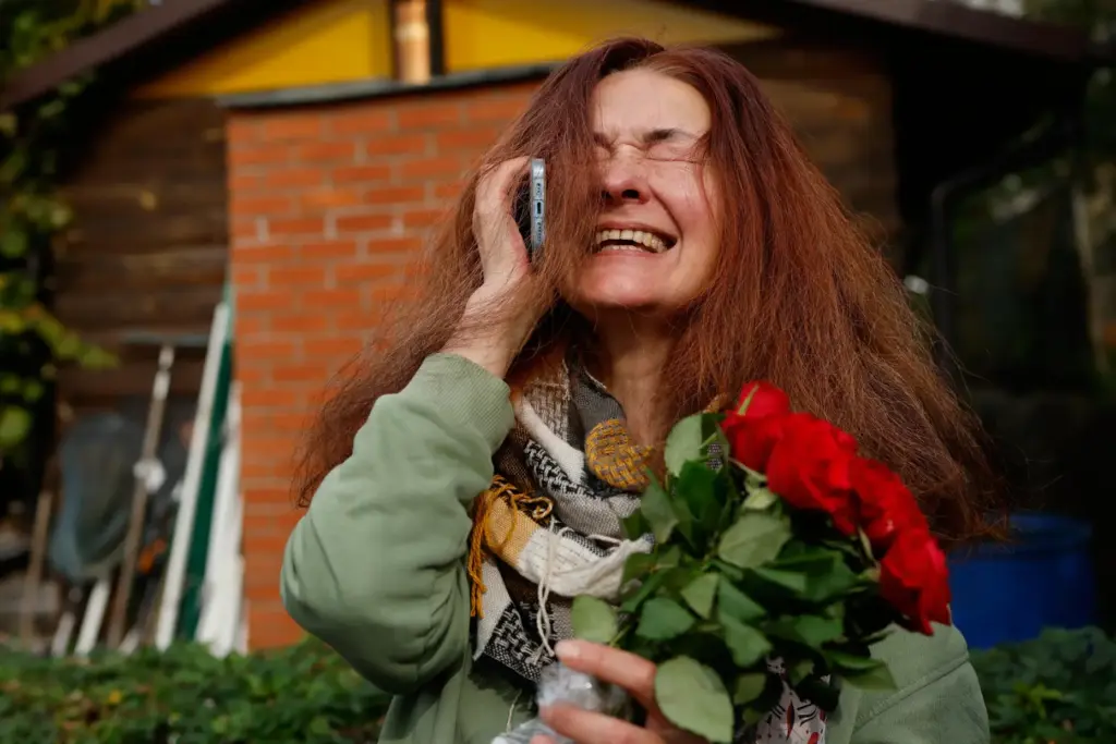 Tatsiana Kouzina, one of the released Belarusian prisoners reacts as...