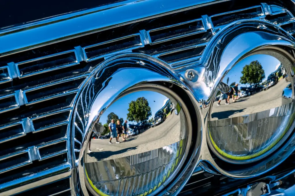 Classic car enthusiasts reflected in Eduardo Floresâ black 1962 Lincoln...