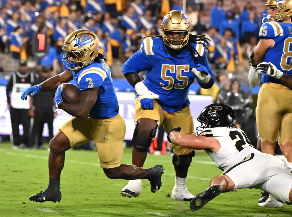 Running back Wayne Knight (3) of the UCLA Bruins runs...