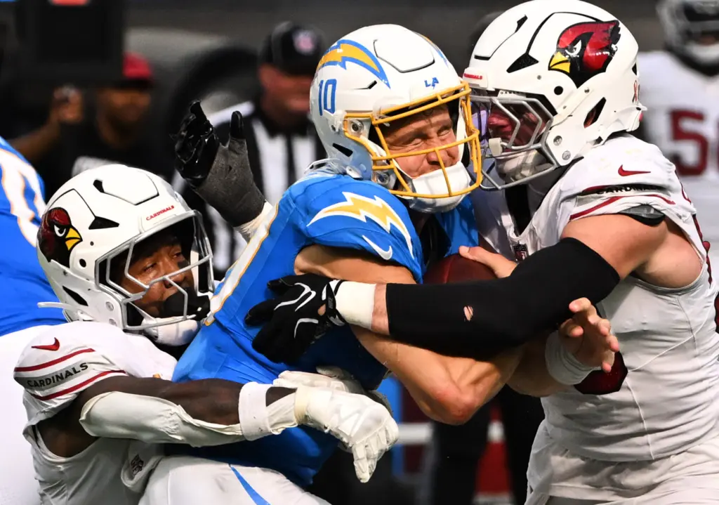 Quarterback Justin Herbert (10) of the Chargers is sacked by...