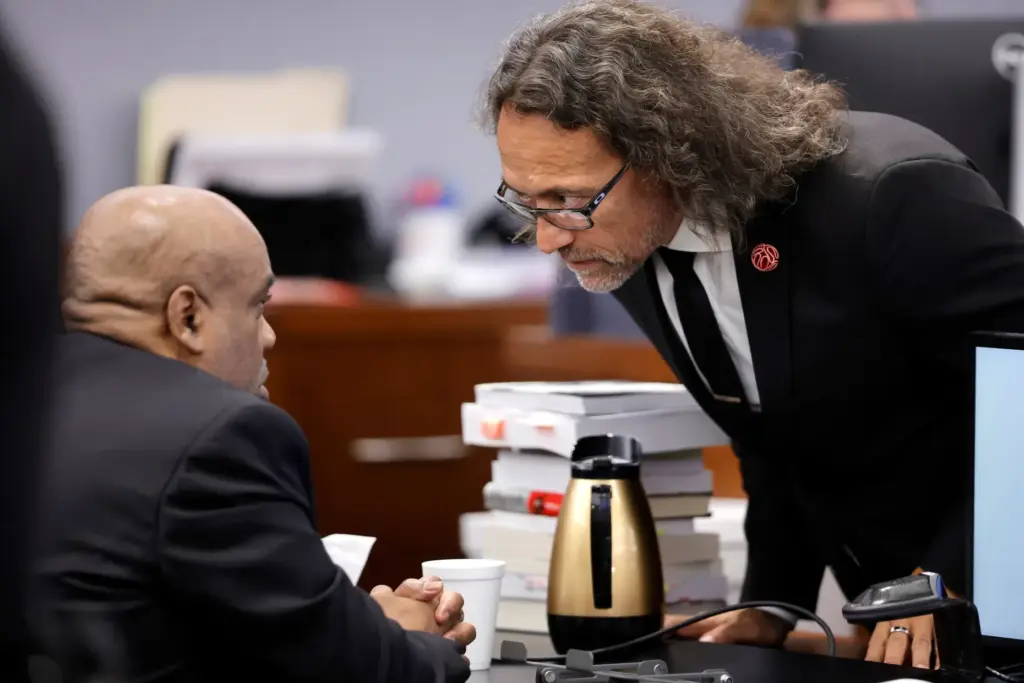 Duane Davis speaks with defense attorney Michael Sanft during closing arguments.