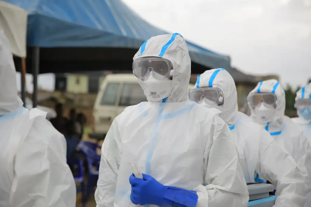 Ebola response teams organize a public demonstration to raise awareness...