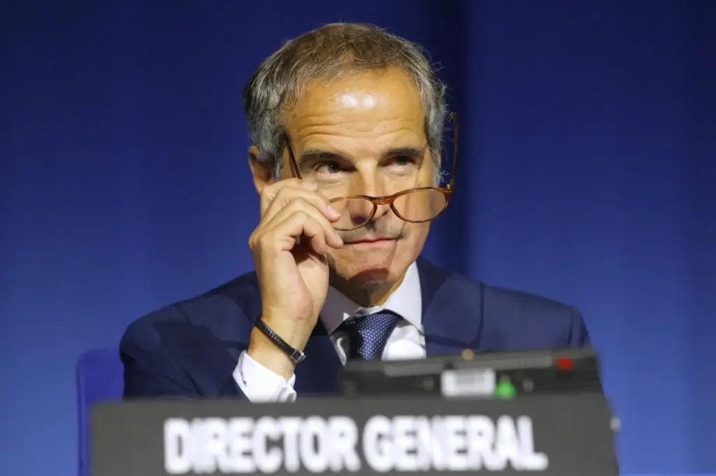 IAEA Director General Rafael Grossi watches from the podium.