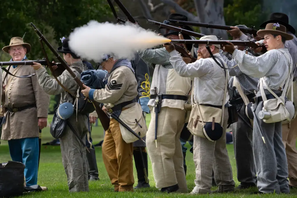 Confederate soldiers point their guns at fighters with the Union...