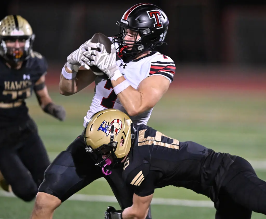 Luke Dolmat #7 of roy catches a pass while guarded...
