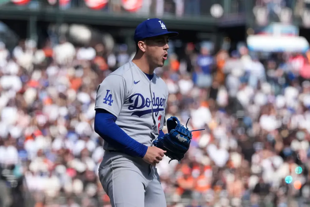 Dodgers pitcher Bobby Miller reacts after striking out the side...