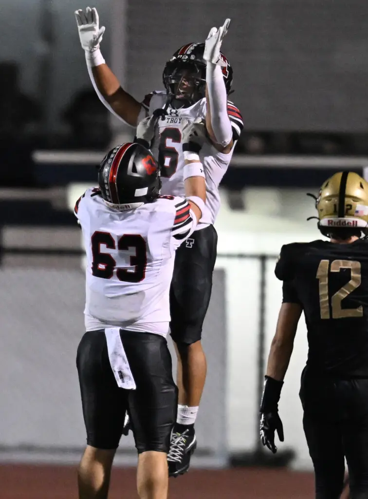 Zachary Blume #63 of Troy lifts Riley Billington #6 after...