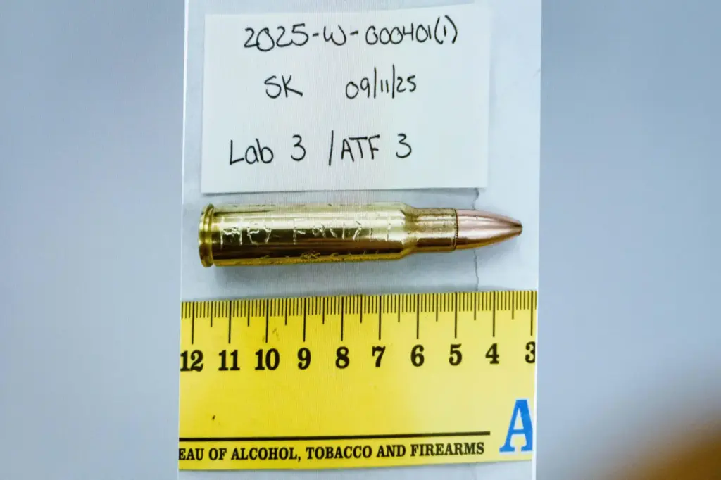 An image of a bullet casing engraved with the words, 