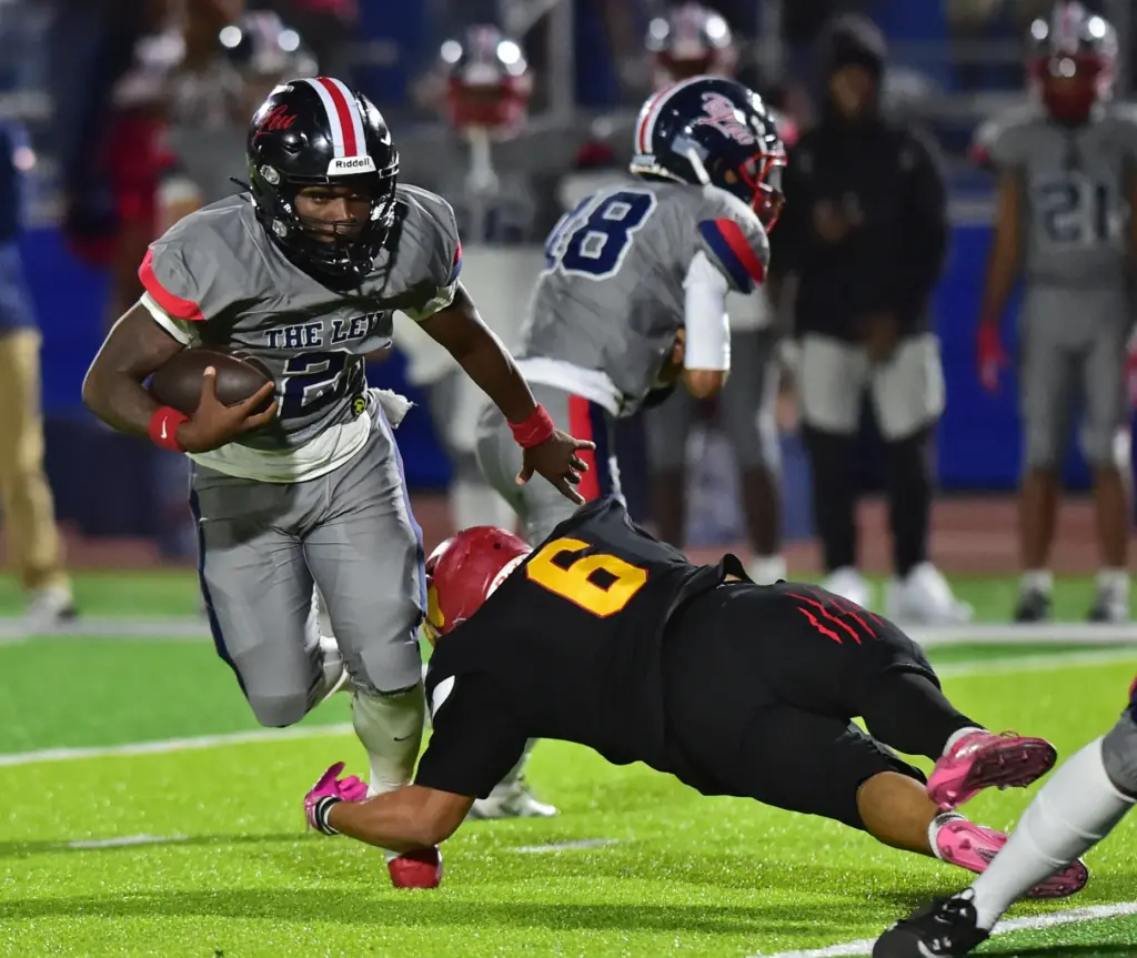 Leuzinger back Milton Jefferson escapes tackle of Hawthorne’s Steven Pulido...