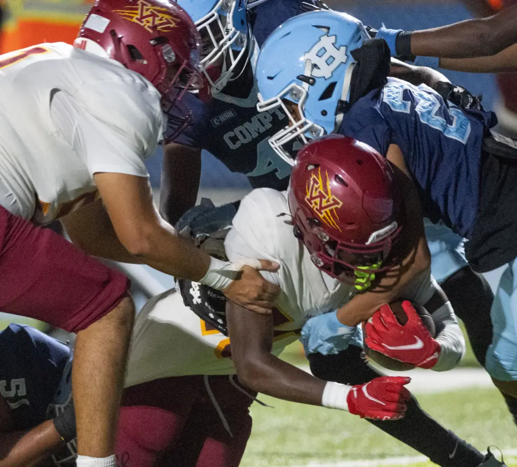 Long Beach Wilson’s Jemel Grigsby is stopped short of the...