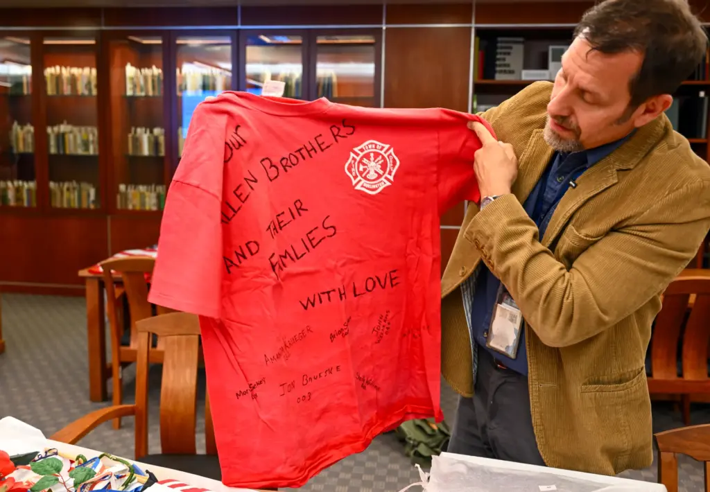 Professor David G. Schwartz looks over artifacts that were part...