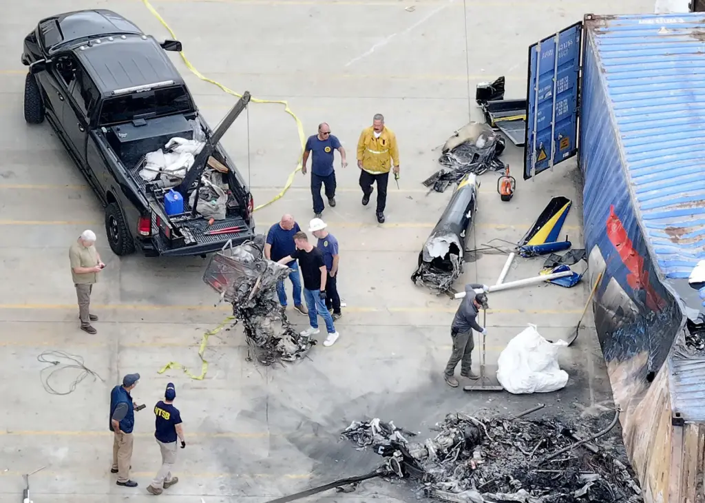 The NTSB supervises the removal of the NBC4 helicopter from...