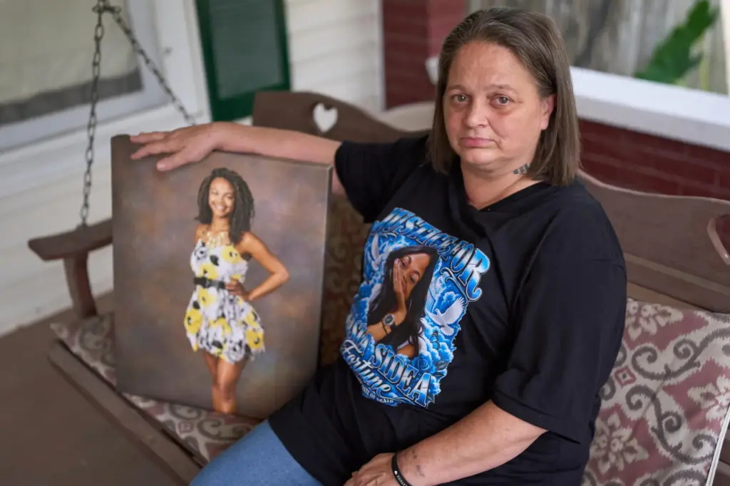 Christy Spivey poses with a portrait of her late daughter,...