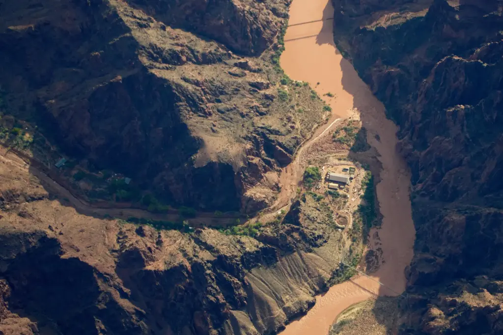 Bright Angel Canyon, damaged by flash floods, runs into the Colorado River.
