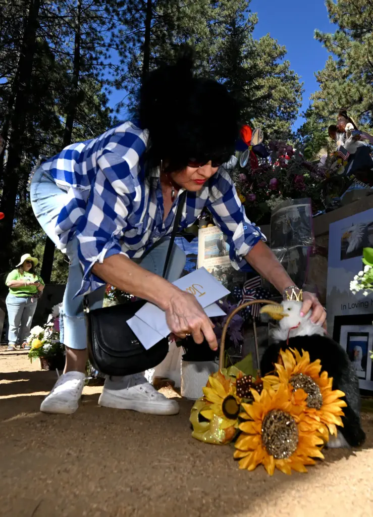 Alison Sotomayer, from Anaheim, leaves a bald eagle figure at...