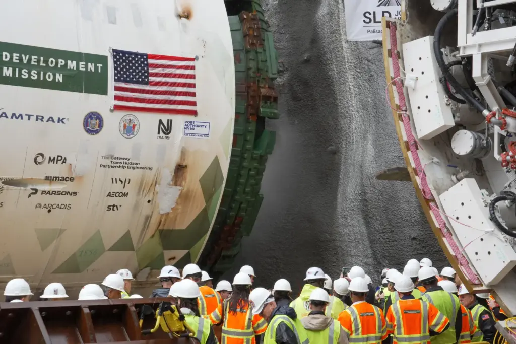 Officials gather between two tunnel-boring machines in North Bergen, N.J.,...