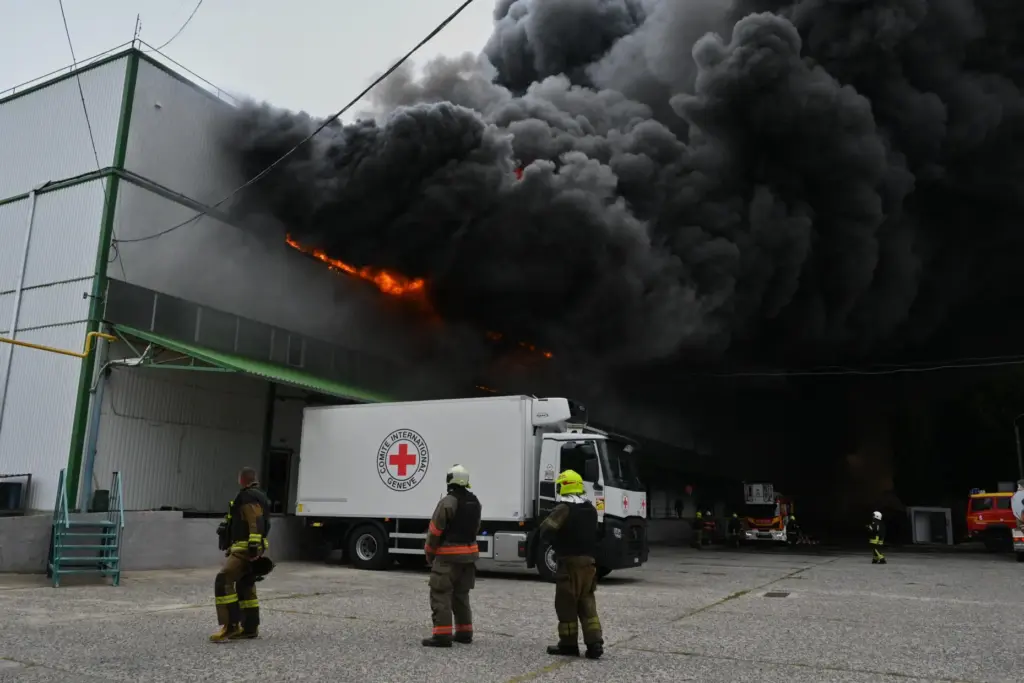 Firefighters put out a fire at warehouse stores after a...