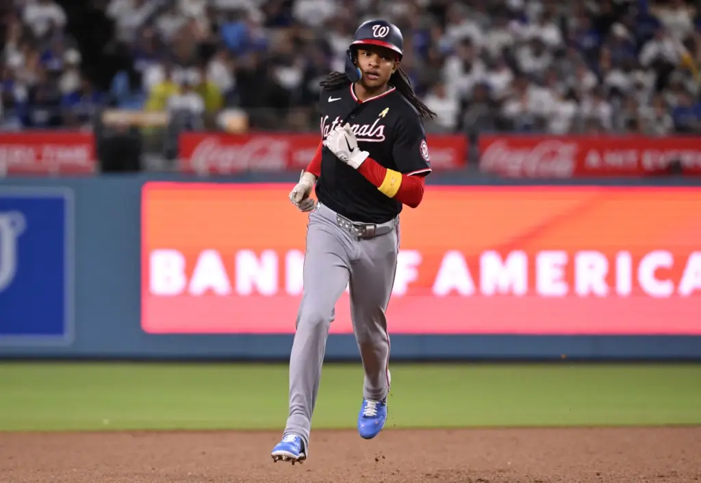 Washington Nationals shortstop CJ Abrams rounds second base after hitting...