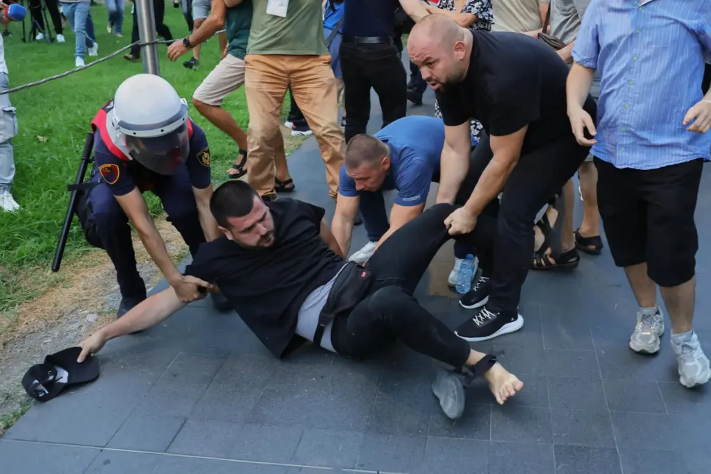 Police officers, most of them in plainclothes, try to detain...